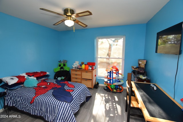 bedroom featuring ceiling fan and dark hardwood / wood-style floors