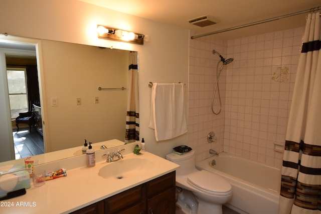 full bathroom with shower / bath combination with curtain, vanity, and toilet