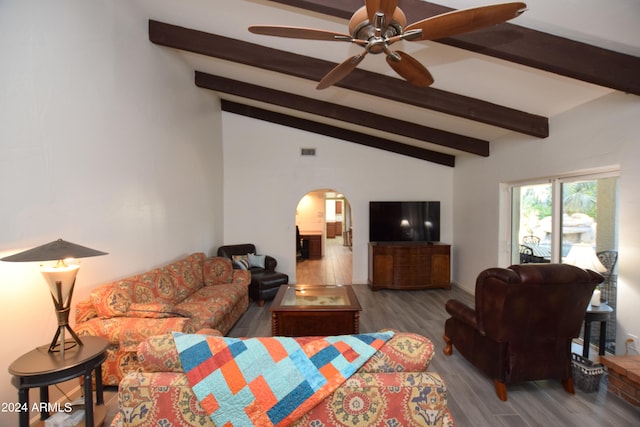 living room with ceiling fan, vaulted ceiling with beams, and dark wood-type flooring