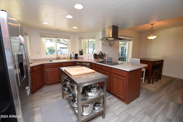 kitchen with a center island, hanging light fixtures, appliances with stainless steel finishes, island exhaust hood, and sink