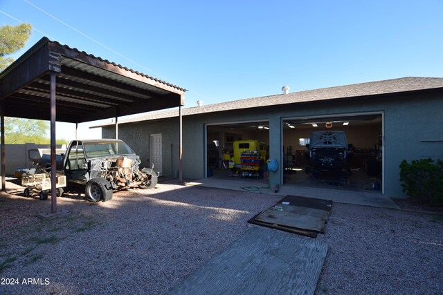 rear view of property with a garage