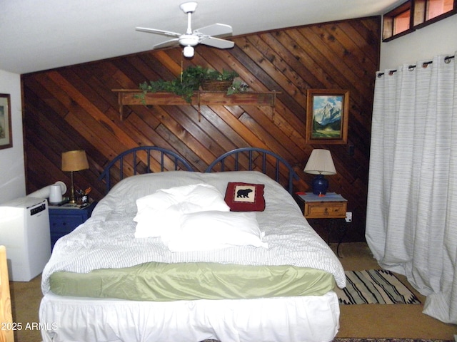 bedroom with ceiling fan, lofted ceiling, and wooden walls