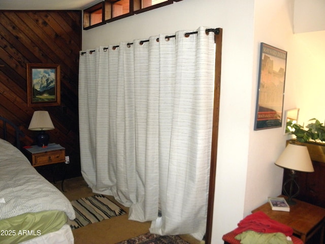 bedroom featuring wood walls