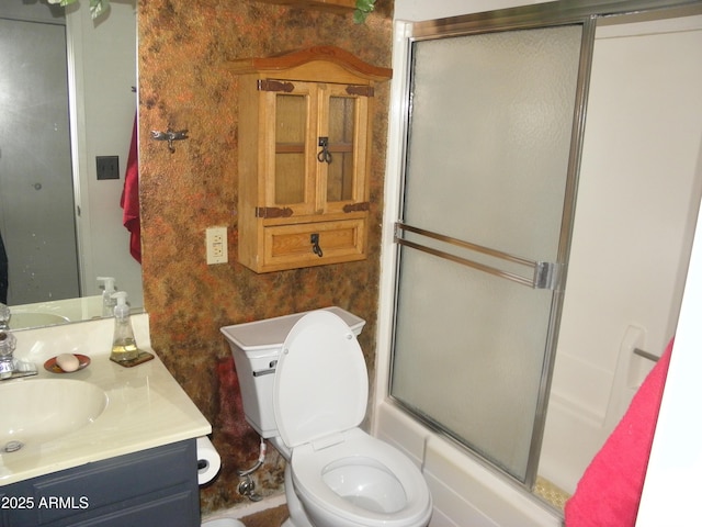 full bathroom featuring vanity, enclosed tub / shower combo, and toilet