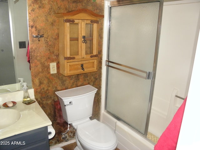 full bathroom with vanity, bath / shower combo with glass door, and toilet