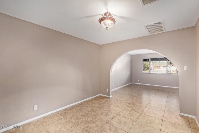 unfurnished room with light tile patterned floors