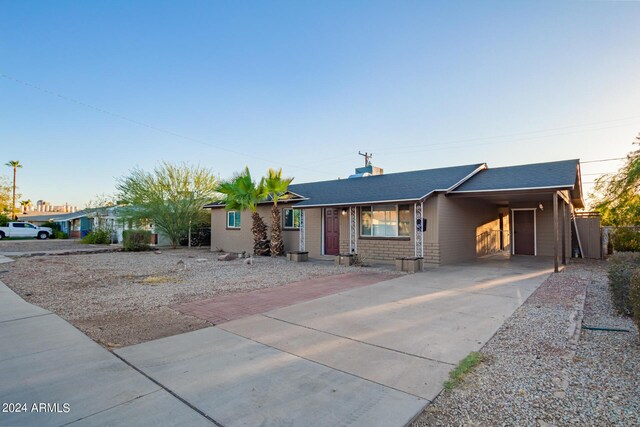 single story home featuring a carport