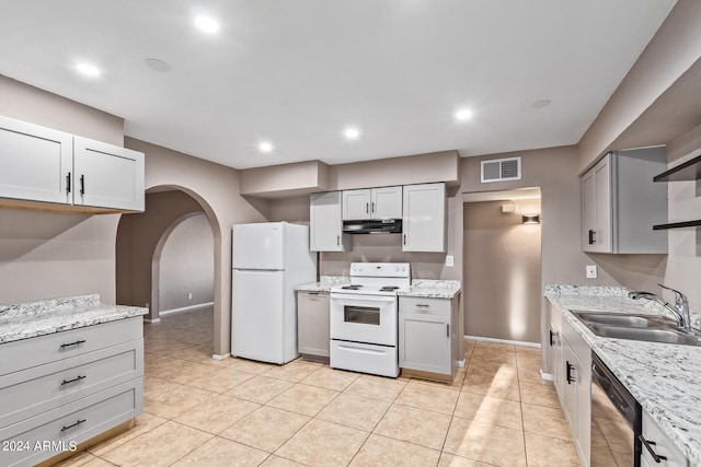 kitchen with sink, gray cabinets, white appliances, and light tile patterned floors