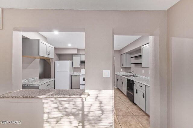 kitchen featuring sink, white appliances, light tile patterned floors, and gray cabinets