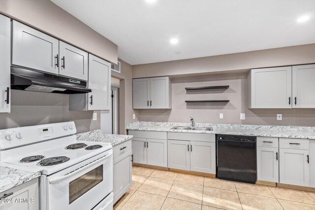 kitchen with black dishwasher, sink, white electric range oven, light stone countertops, and light tile patterned floors