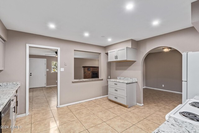 kitchen with dishwasher, ceiling fan, white fridge, and light tile patterned floors