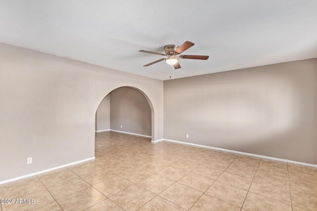 tiled empty room with ceiling fan