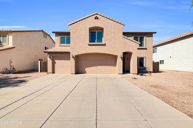 mediterranean / spanish-style house featuring stucco siding, concrete driveway, an attached garage, and a tile roof