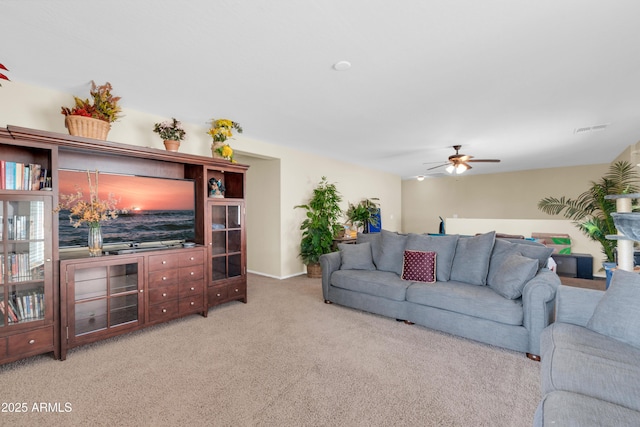 living room with carpet flooring, ceiling fan, and visible vents