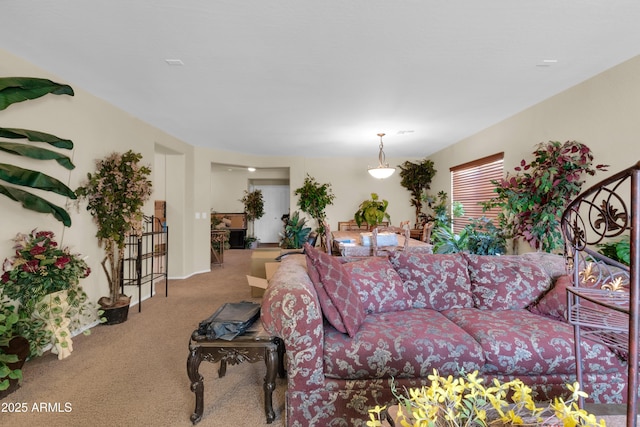 carpeted living room featuring stairway