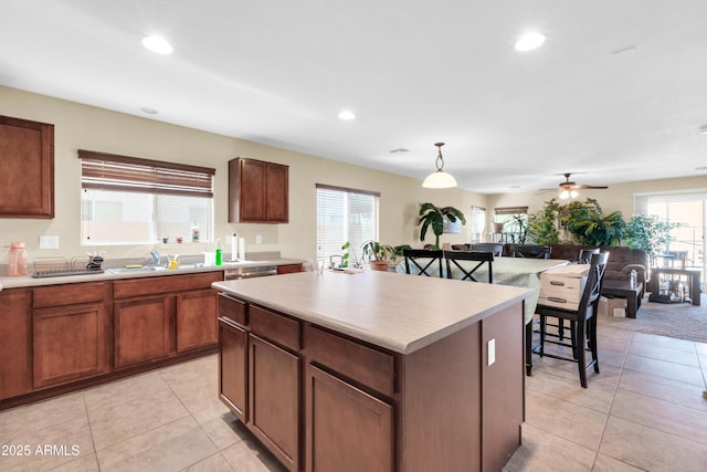 kitchen featuring light countertops, light tile patterned flooring, recessed lighting, and a kitchen island