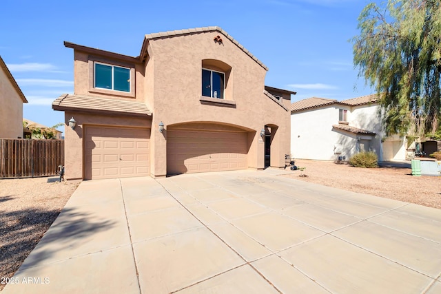 view of front of property with stucco siding, driveway, an attached garage, and a tiled roof