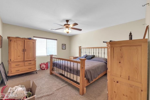 bedroom featuring light colored carpet and a ceiling fan