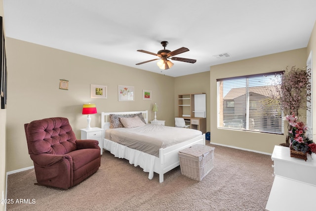 carpeted bedroom with visible vents, a ceiling fan, and baseboards