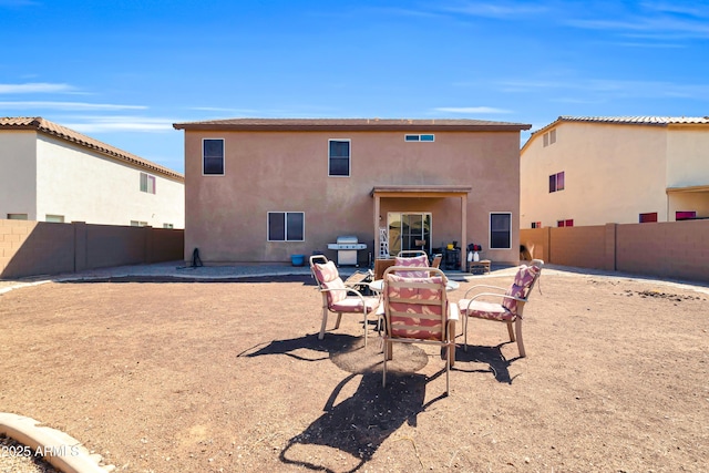 back of property with a patio, a fenced backyard, and stucco siding