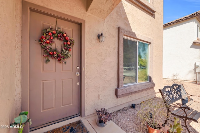 doorway to property with stucco siding