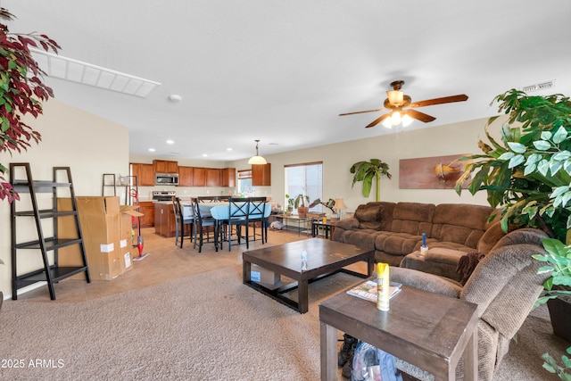 living area with light tile patterned flooring, recessed lighting, visible vents, and ceiling fan