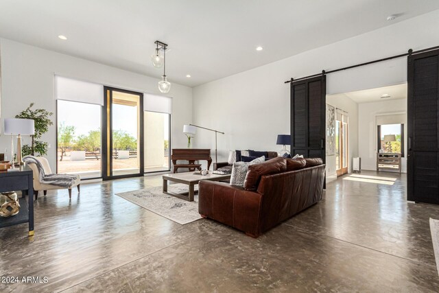 23008 E Galveston St, Mesa, AZ 85212 - living room featuring concrete flooring, a barn door, and recessed lighting