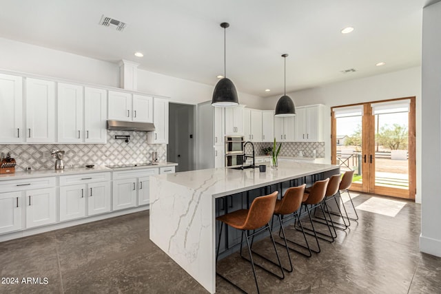 23008 E Galveston St, Mesa, AZ 85212 - kitchen featuring decorative backsplash, under cabinet range hood, white cabinets, and visible vents