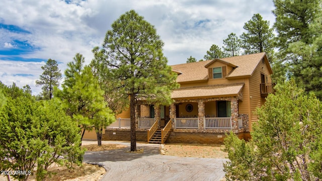 2937 Ransack Rd, Overgaard, AZ 85933 - view of front of house featuring covered porch, stone siding, and roof with shingles