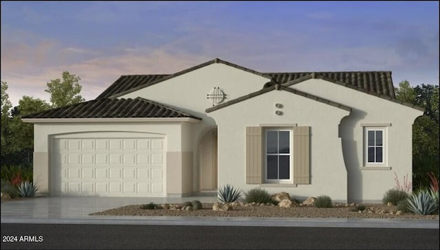 view of front of house featuring a garage, concrete driveway, and stucco siding