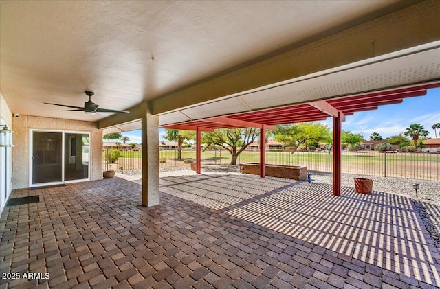view of patio / terrace featuring ceiling fan and fence