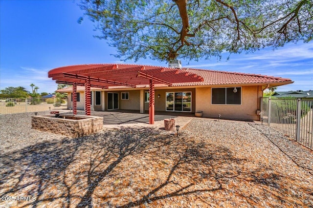 back of property with a pergola, a fenced backyard, stucco siding, a patio area, and a tile roof