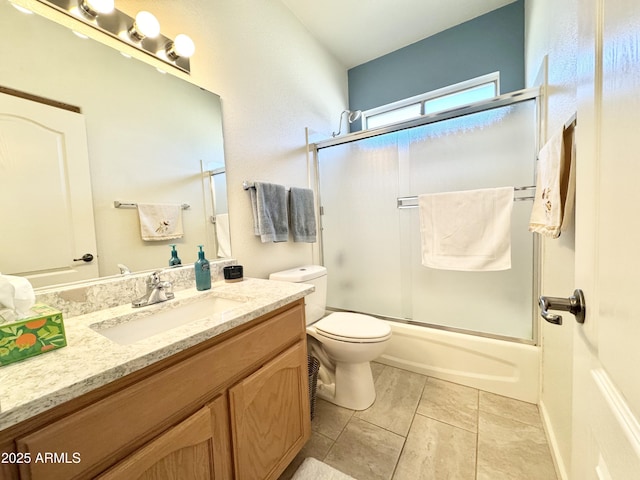 full bath with vanity, toilet, and shower / bath combination with glass door