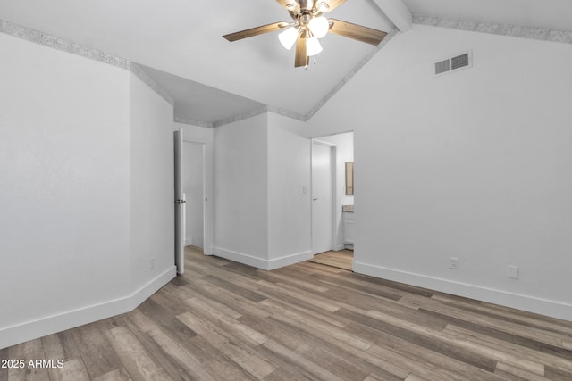 spare room featuring baseboards, visible vents, ceiling fan, wood finished floors, and beamed ceiling