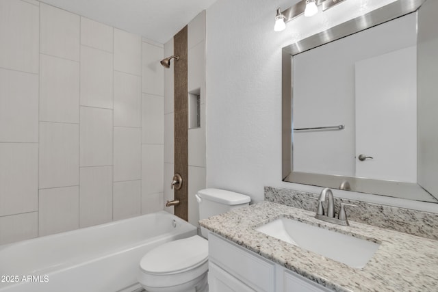 full bath with toilet, a textured wall, washtub / shower combination, and vanity