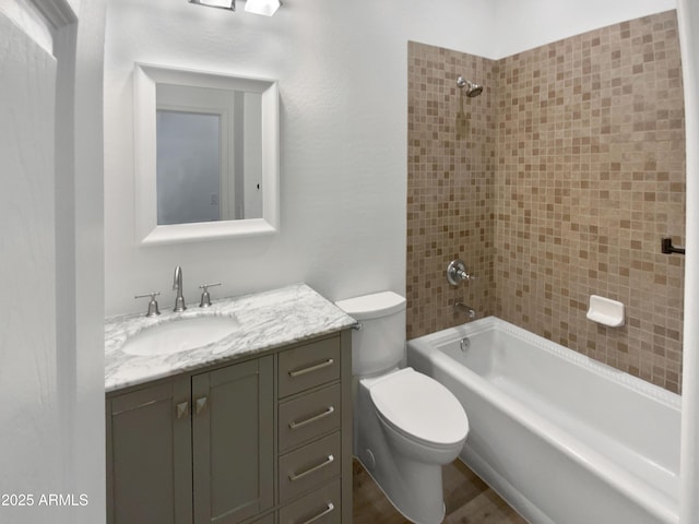 bathroom featuring toilet, vanity, bathing tub / shower combination, and wood finished floors