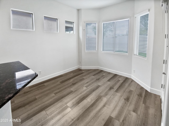 unfurnished room with wood finished floors and baseboards