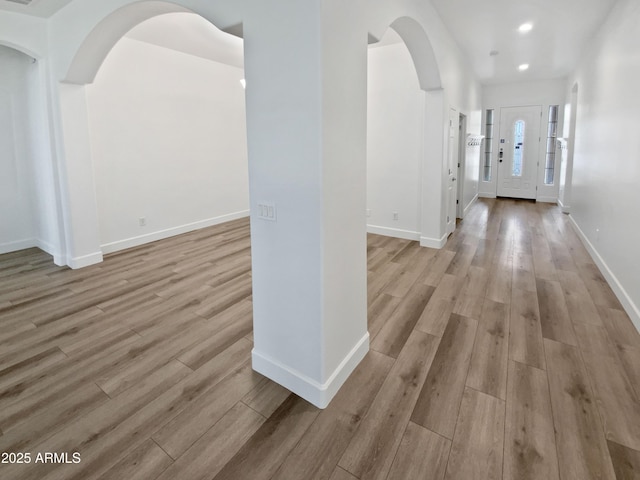 foyer featuring light wood-style flooring and baseboards