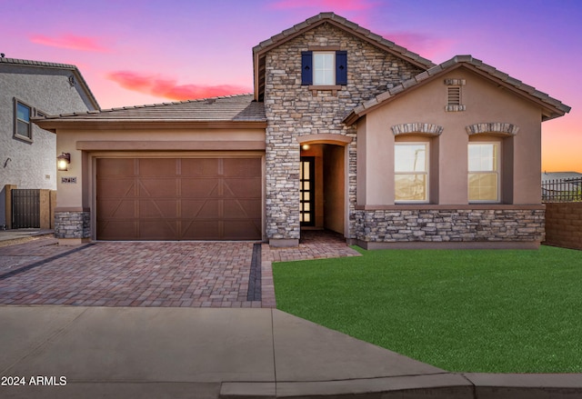 view of front facade with a lawn and a garage