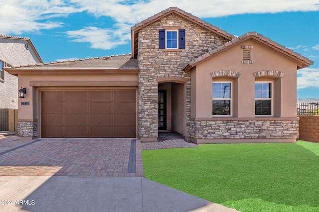 view of front of property with a garage and a front yard