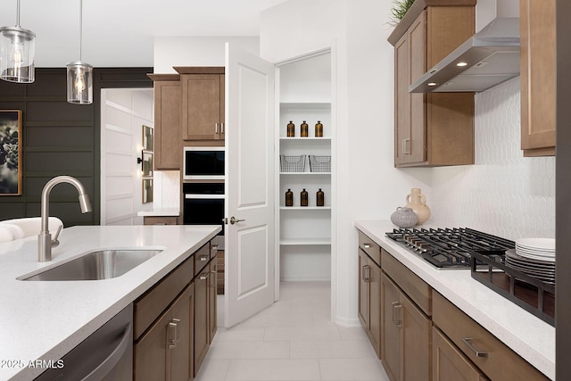 24223 W Illini St, Buckeye, AZ 85326 - kitchen with wall chimney range hood, stainless steel appliances, light tile patterned floors, pendant lighting, and light stone counters