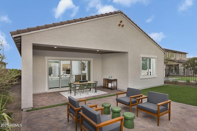 24223 W Illini St, Buckeye, AZ 85326 - rear view of property featuring stucco siding, a patio area, and outdoor dining space