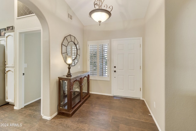 foyer with dark hardwood / wood-style flooring and lofted ceiling