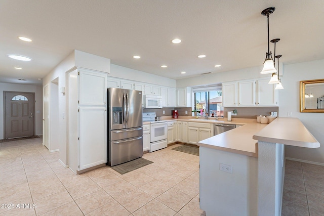 kitchen with kitchen peninsula, white cabinets, and stainless steel appliances