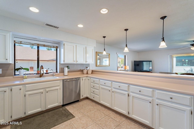 kitchen with white cabinets, dishwasher, sink, and hanging light fixtures