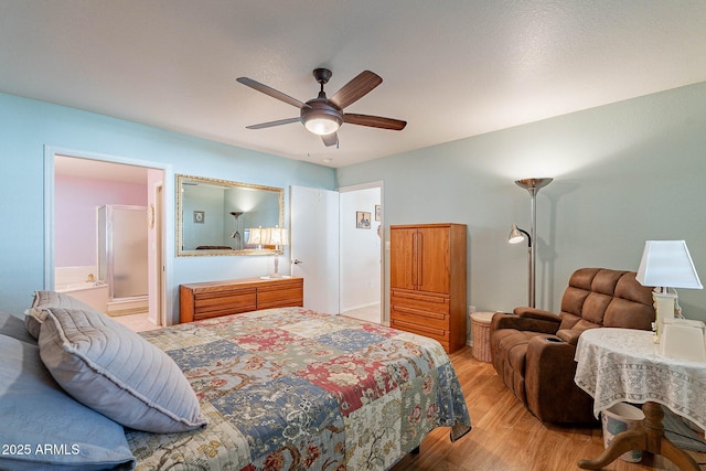 bedroom featuring connected bathroom, ceiling fan, and light hardwood / wood-style flooring