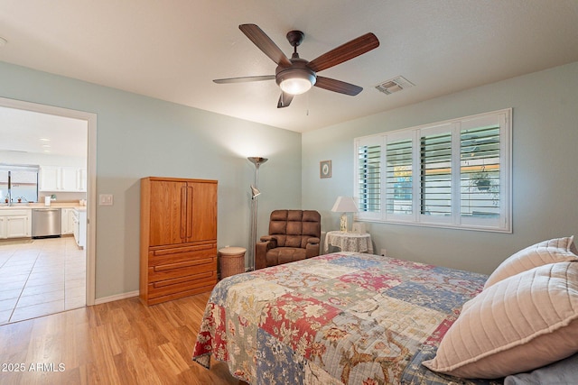 bedroom featuring ceiling fan, light hardwood / wood-style flooring, and sink