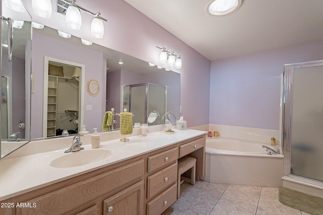 bathroom featuring tile patterned flooring, vanity, and shower with separate bathtub