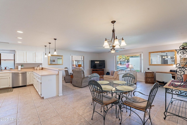 dining room featuring ceiling fan, light tile patterned floors, and sink