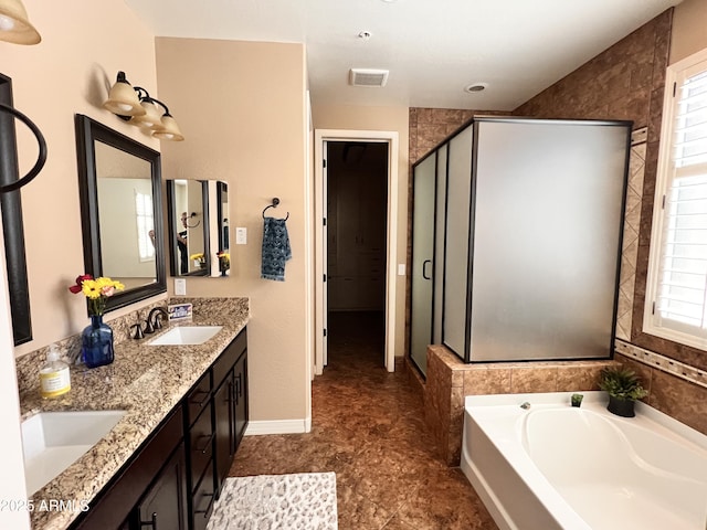 full bathroom with a garden tub, double vanity, visible vents, a sink, and a shower stall